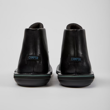 Black shoes with 'Camper' branding on a white background