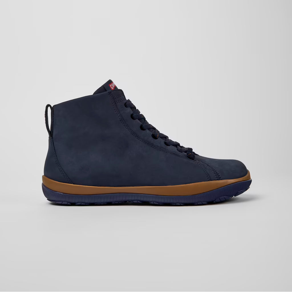 Navy high-top sneaker with brown sole on a light gray background